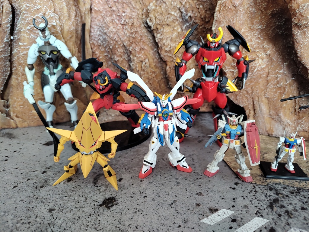 Pictured above is a comparison shot with the Revoltech figures in the background plus the smaller Konami Gurren Lagann trading figure. In the foreground we have a 1/220 Burning Gundam in the center, a 1/300 Gundam then a 1/400 Gundam on the right.